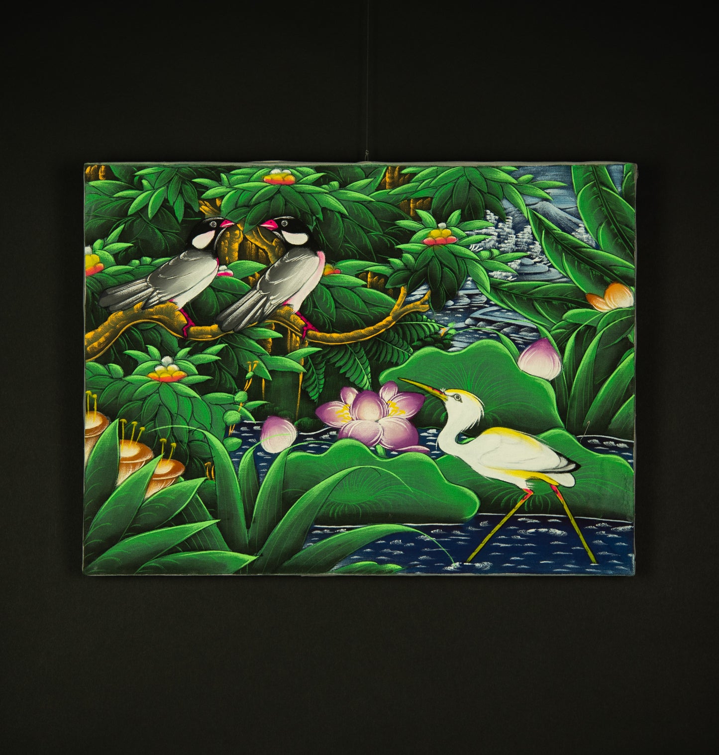 A colorful painting of a tropical pond scene with two birds on branches, a white egret standing in the water, pink flowers, and lush green foliage, displayed against a dark background.